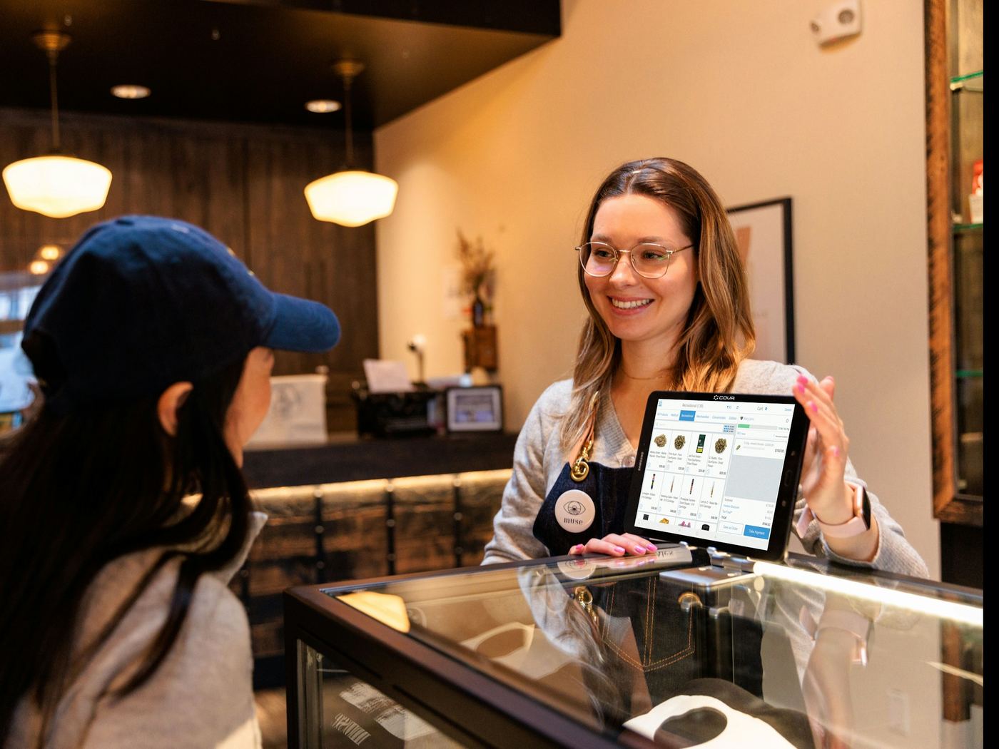 A shop assistant serving a customer at a counter